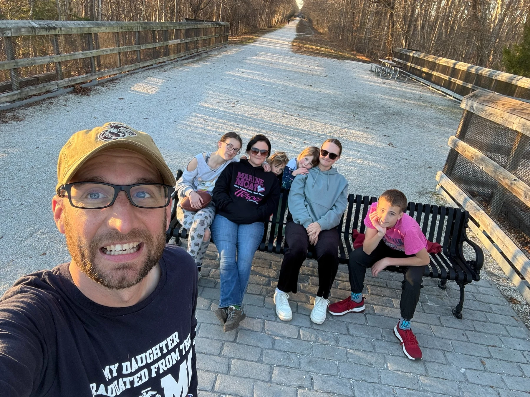 The Miller family together on a sunny woodland trail